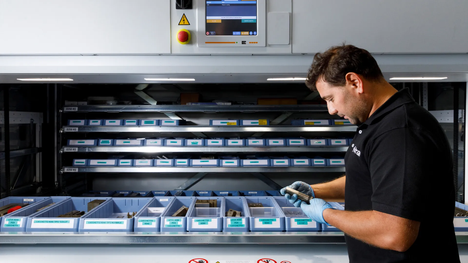Sifral operator inspecting a metal component at the automated vertical warehouse