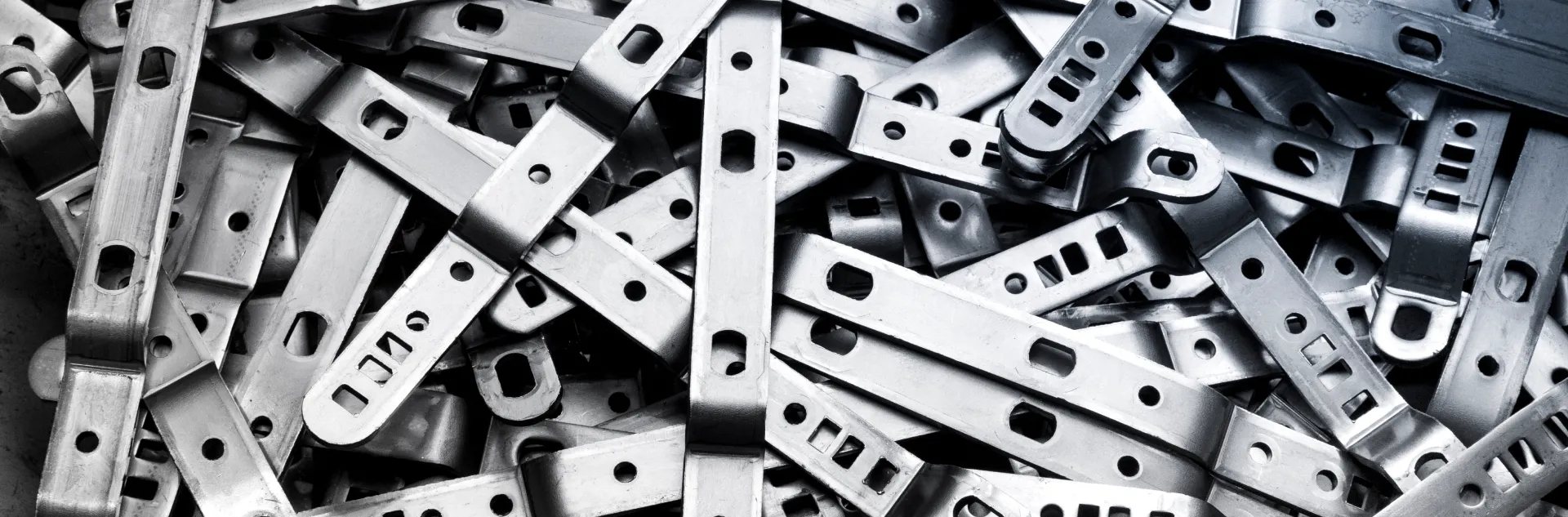 Cold-formed sheet metal brackets with rectangular holes and bent edges